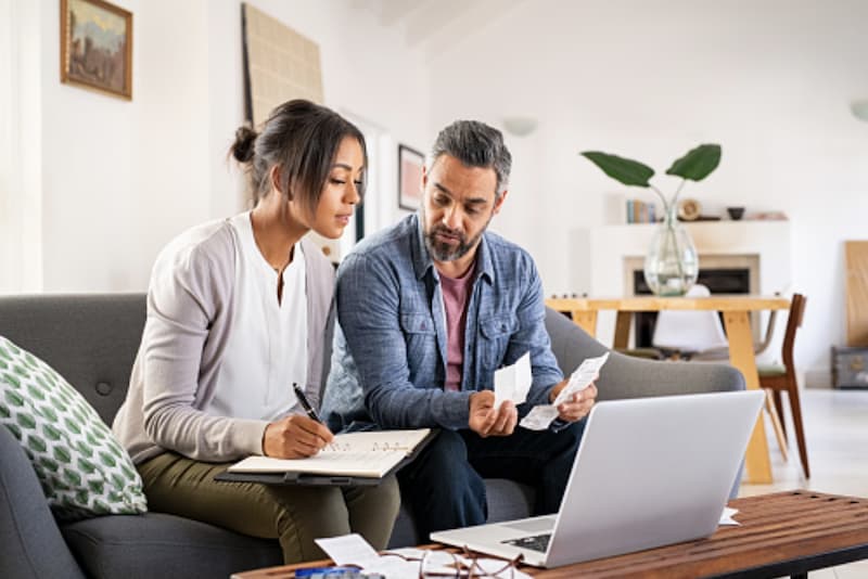 Couple comparing prices of of new home ac unit